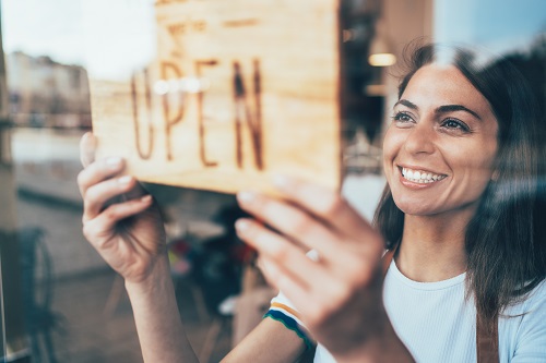 business owner flipping open sign